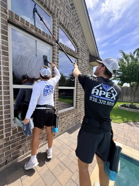 Apex Cleaning Co. technicians cleaning windows